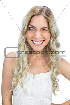 Smiling blue eyed model winking at camera