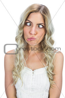 Funny blonde squinting while posing
