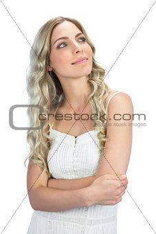 Pensive sexy blonde crossing arms