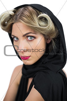 Serious mysterious blonde wearing black clothes posing