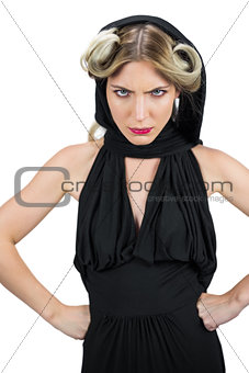 Domineering creepy blonde wearing black clothes frowning