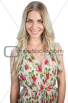 Cheerful blonde wearing flowered dress posing