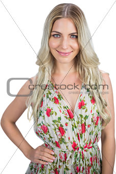 Happy blonde wearing flowered dress posing