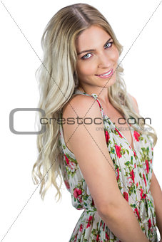 Smiling attractive blonde wearing flowered dress posing