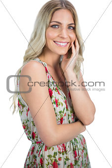 Happy pretty blonde wearing flowered dress posing
