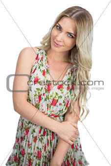 Relaxed seductive blonde wearing flowered dress posing