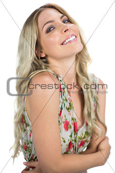 Cheerful seductive blonde wearing flowered dress posing
