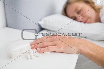 Blonde woman lying motionless after overdose of medication