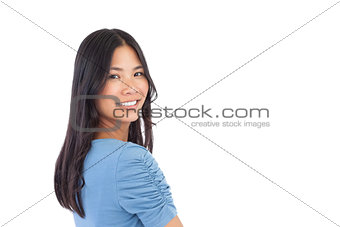 Smiling asian woman looking over her shoulder