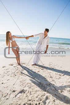Happy couple holding hands and leaning to either side