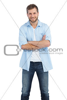 Smiling man crossing arms