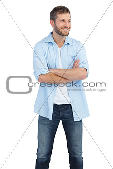 Smiling man crossing arms and looking away