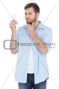 Handsome model holding a bulb
