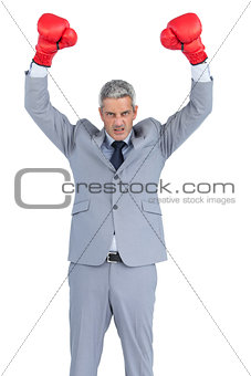 Furious businessman posing with red boxing gloves