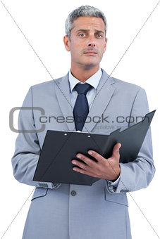 Self assured businessman with clipboard