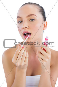 Young model applying lip gloss