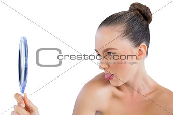 Woman looking in the mirror and sticking tongue out