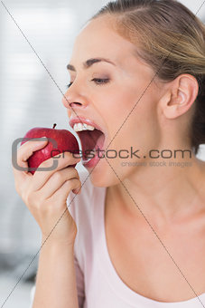 Pretty woman munching apple in close up