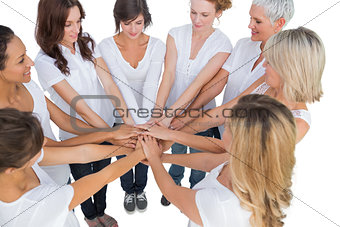 Peaceful female models joining hands in a circle