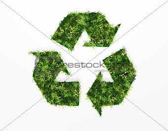 recycling symbol covered by grass and flowers