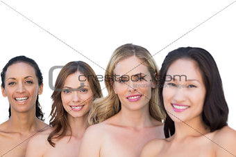Smiling nude models posing in a line with brunette on background