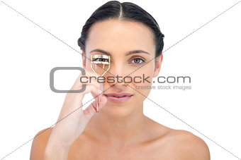 Delightful natural brunette using eyelash curler