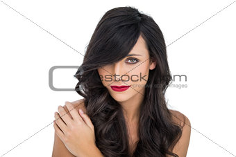 Glamorous brunette posing with hand on her shoulder
