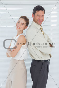 Cheerful business team posing back to back