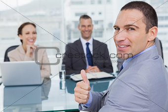 Applicant giving thumb up after obtaining the job