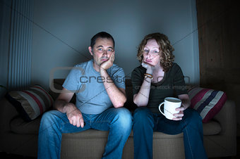 couple watching television bored