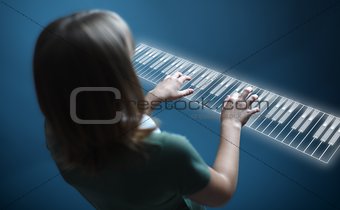 Girl playing on virtual piano keyboard