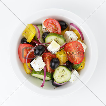 fresh greek salad in white bowl