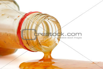 Piquant red sauce leaking from the bottle