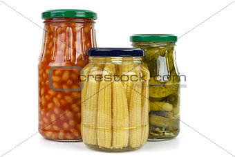 Glas jars with cornichons, haricot beans and corn ears