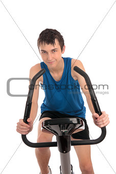 Teenage boy using an exercise bike fitness