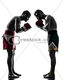 two men exercising thai boxing salute  silhouette