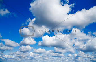 blue sky with white cumulus clouds as natural background