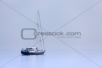 Lonely yacht in calm blue sea