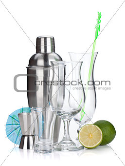 Cocktail shaker, glasses, utensils and lime