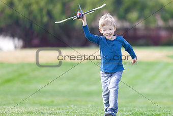 boy playing toy plane