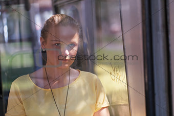Young woman in yellow rides the bus