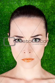 Portrait of a serious beautiful woman with green eyes and glossy