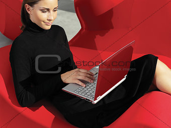 woman with laptop on the sofa a