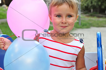 adorable little girl playing with balloons