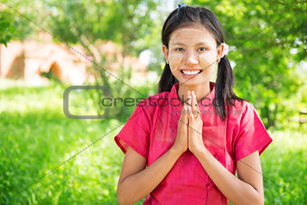  Myanmar girl in welcoming pose at outdoor.