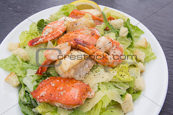Caesar Salad with Prawns Salmon and White Fish Closeup