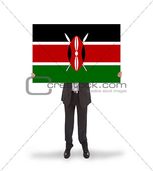 Businessman holding a big card, flag of Kenya