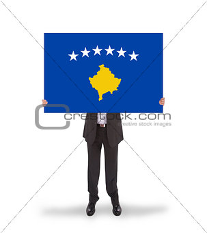 Businessman holding a big card, flag of Kosovo