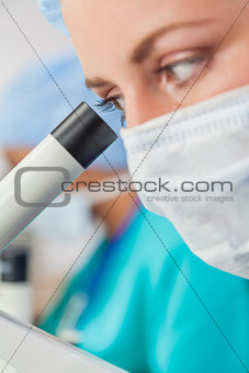 Female Woman Scientist Using Microscope in Laboratory