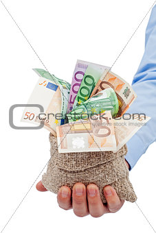 Businessman hand with a bag full of euro banknotes